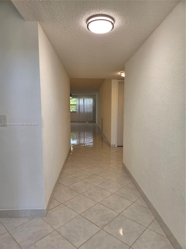 2606 NW 104th Ave Unit 202, Sunrise, FL 33322 - hallway featuring a textured ceiling, a textured wall, and light tile patterned floors
