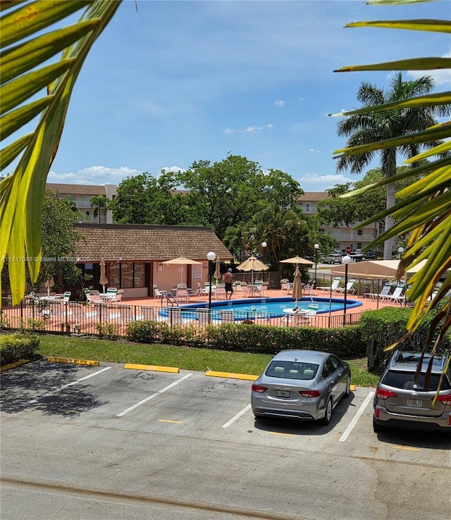 2606 NW 104th Ave Unit 202, Sunrise, FL 33322 - uncovered parking lot featuring a community pool
