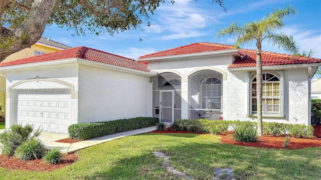 mediterranean / spanish-style home featuring a garage and a front lawn