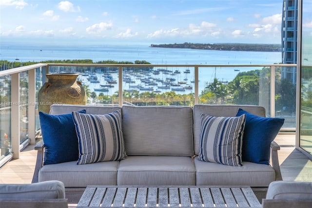 balcony with an outdoor hangout area and a water view