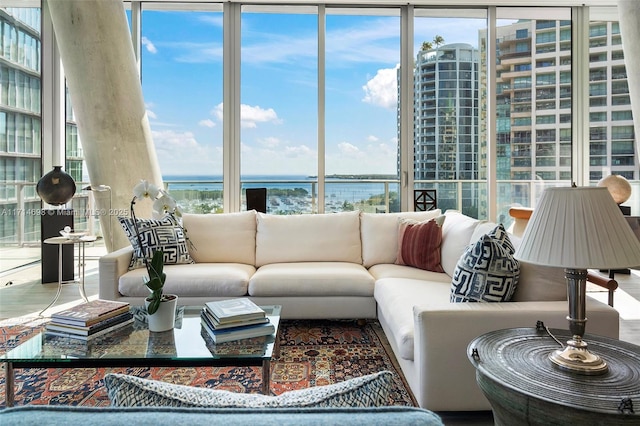 living room with a water view and expansive windows