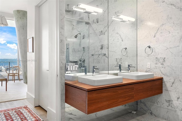 bathroom featuring vanity, hardwood / wood-style flooring, a wealth of natural light, and a water view