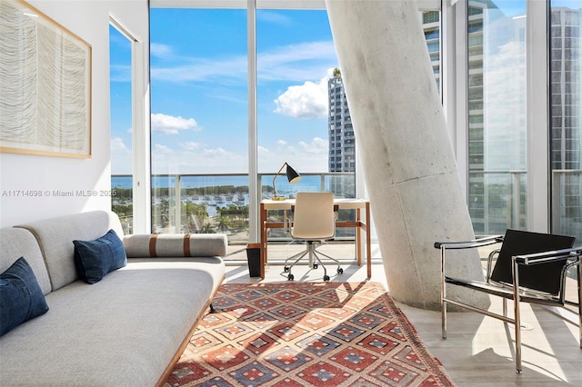 interior space with light wood-type flooring and floor to ceiling windows