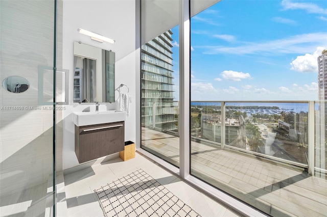 balcony featuring a water view and sink