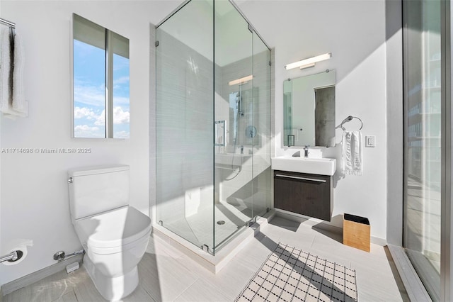 bathroom featuring vanity, tile patterned flooring, a shower with shower door, and toilet