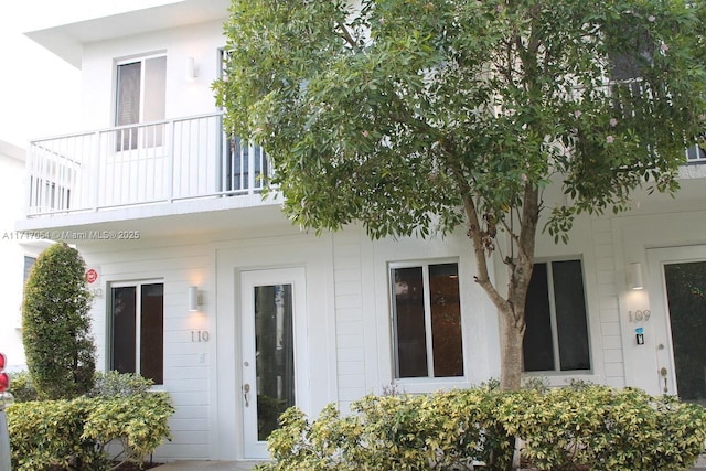 rear view of property featuring a balcony