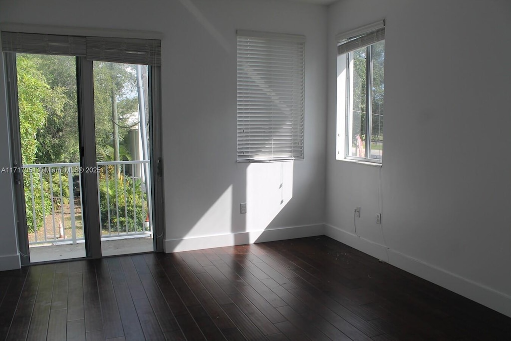 unfurnished room featuring dark hardwood / wood-style flooring