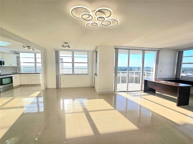 18051 Biscayne Blvd Unit 1204, Aventura, FL 33160 - unfurnished dining area with light tile patterned flooring, a textured ceiling, and baseboards
