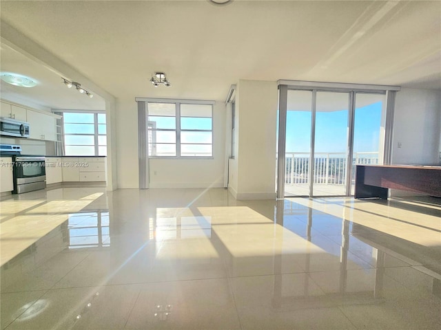 interior space with floor to ceiling windows and baseboards