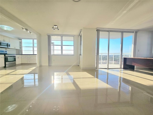 18051 Biscayne Blvd Unit 1204, Aventura, FL 33160 - tiled empty room featuring baseboards