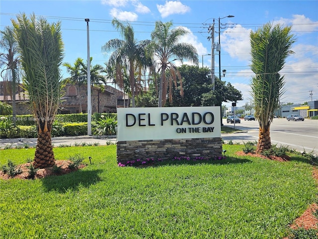 community sign featuring a lawn