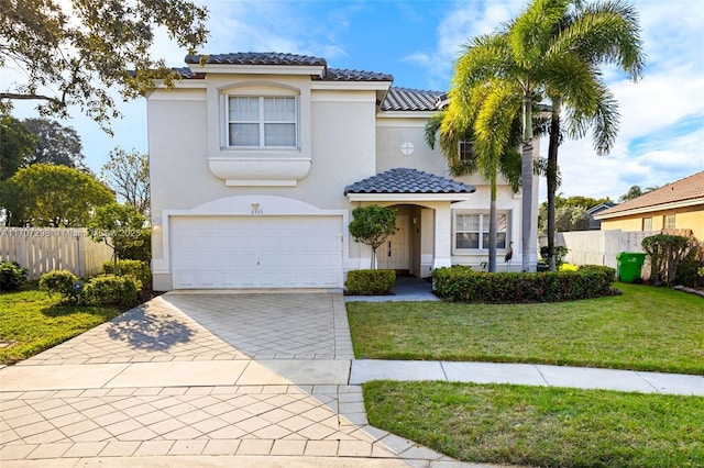 mediterranean / spanish home with a front yard and a garage