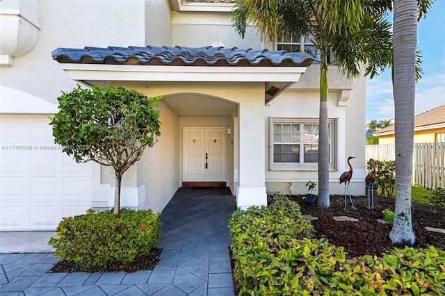 view of exterior entry with a garage