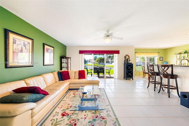 tiled living room featuring ceiling fan and a textured ceiling