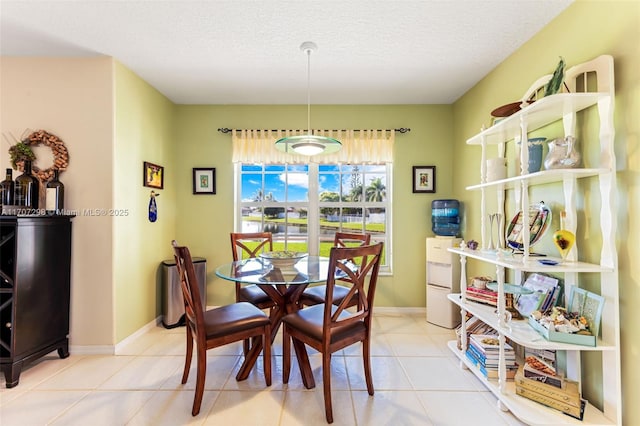 dining room featuring a textured ceiling and light tile patterned flooring