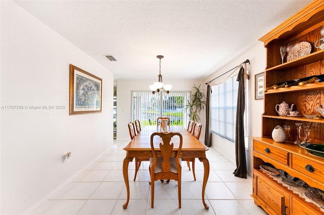 2355 NW 137th Ter, Sunrise, FL 33323 - dining room with a chandelier, a textured ceiling, light tile patterned flooring, and baseboards
