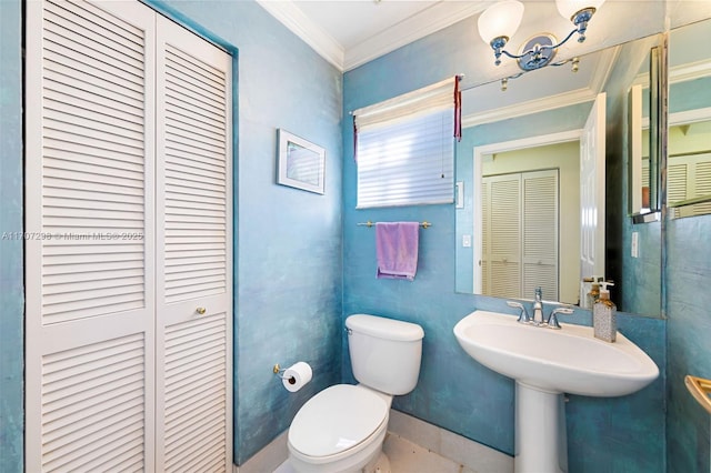 bathroom with sink, toilet, and crown molding