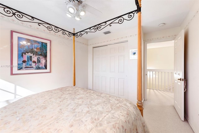 carpeted bedroom featuring ceiling fan and a closet