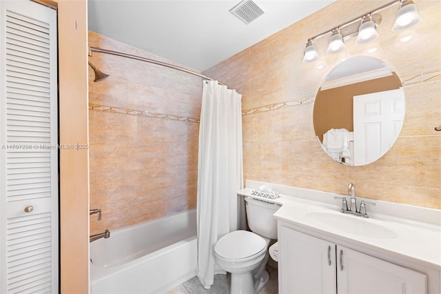 full bathroom featuring tile patterned flooring, toilet, vanity, shower / tub combo, and ornamental molding