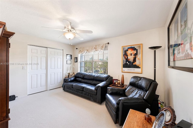 living room with carpet, a textured ceiling, and ceiling fan