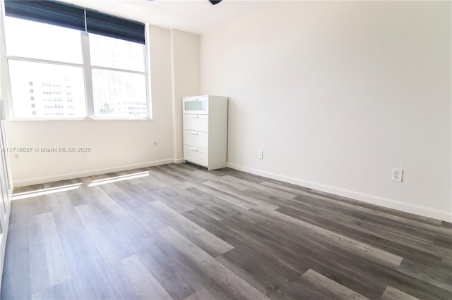 spare room with wood-type flooring