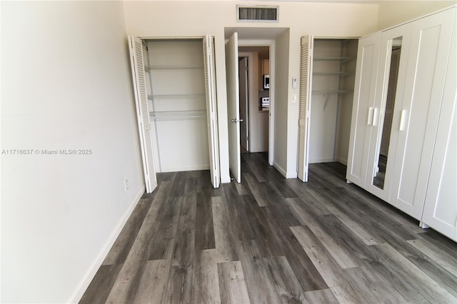 unfurnished bedroom featuring dark hardwood / wood-style flooring