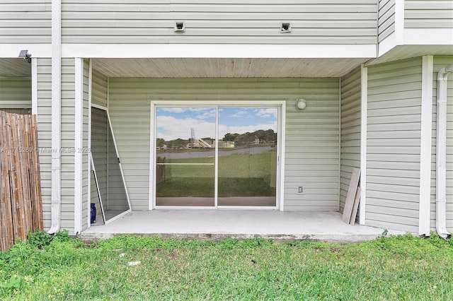 view of exterior entry featuring a patio area