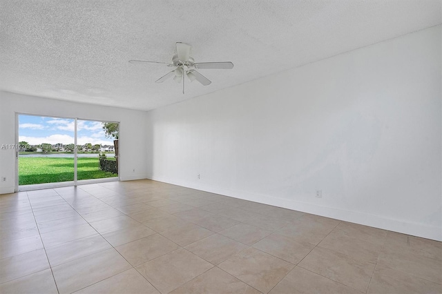 spare room featuring light tile patterned floors and ceiling fan