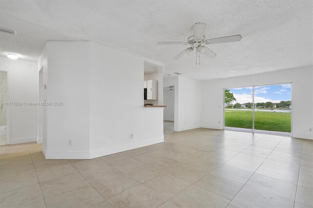 unfurnished room with ceiling fan and light tile patterned flooring