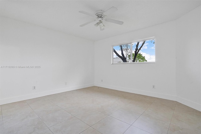 tiled spare room with ceiling fan