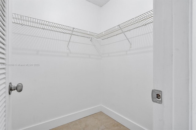 spacious closet featuring tile patterned floors