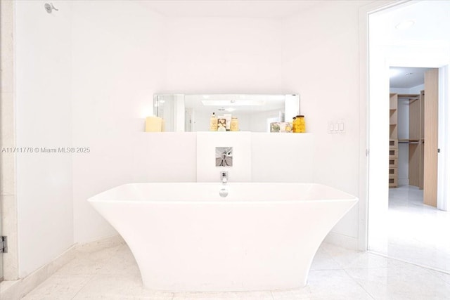 bathroom featuring a soaking tub and tile patterned flooring