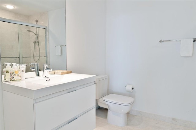 bathroom featuring a stall shower, vanity, and toilet