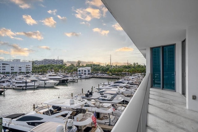 balcony featuring a dock and a water view