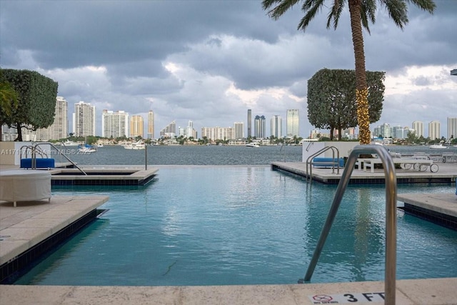 dock area featuring a water view and a city view