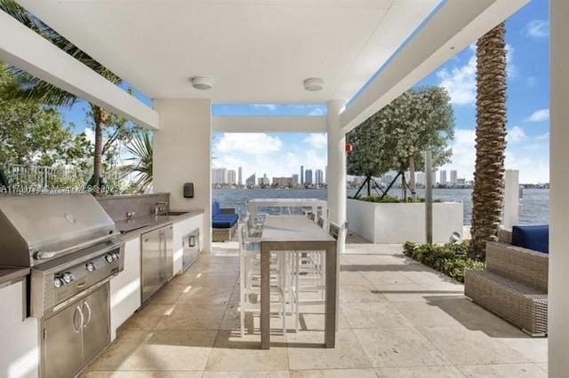 view of patio featuring a view of city, area for grilling, and an outdoor kitchen