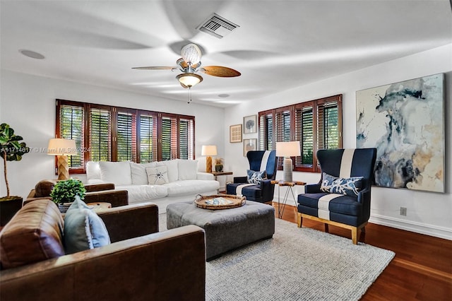 living room featuring ceiling fan and dark hardwood / wood-style floors