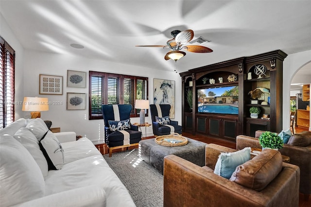 living room with dark hardwood / wood-style floors and ceiling fan