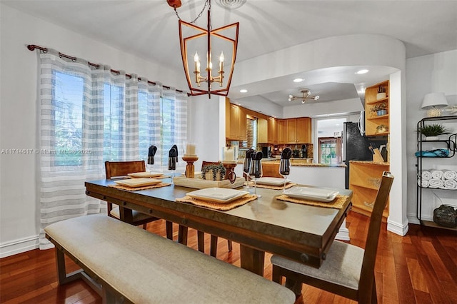 dining space featuring dark hardwood / wood-style floors and a notable chandelier