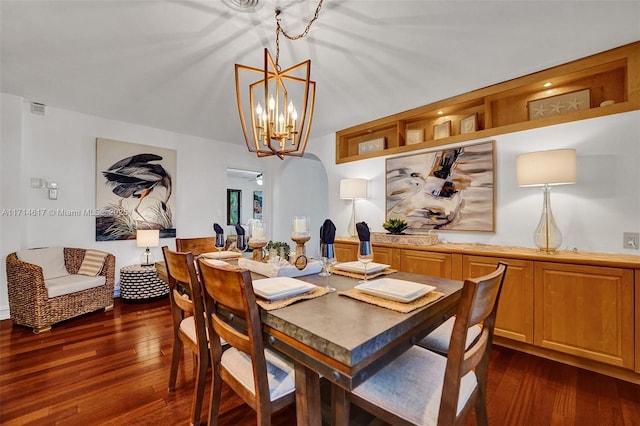 dining room with ceiling fan with notable chandelier and dark wood-type flooring