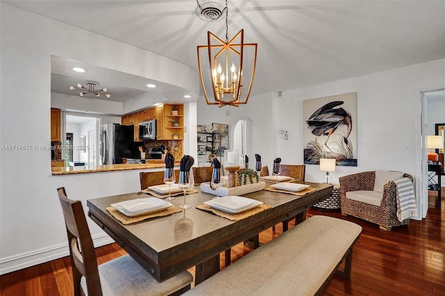 dining space with a notable chandelier and dark hardwood / wood-style floors