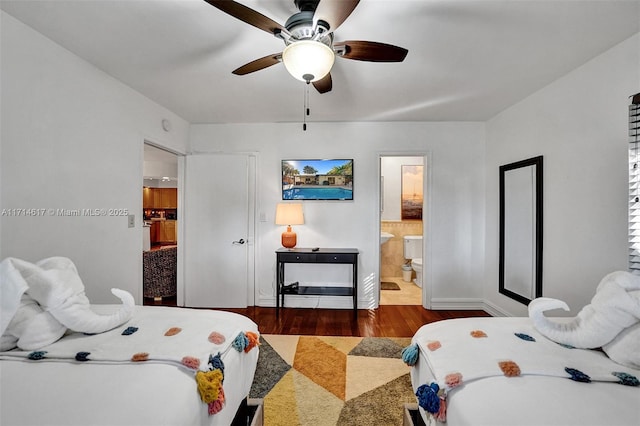 bedroom with connected bathroom, ceiling fan, and dark hardwood / wood-style floors