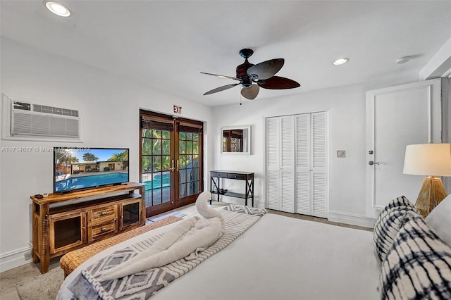 bedroom with french doors, access to outside, a wall mounted AC, ceiling fan, and a closet