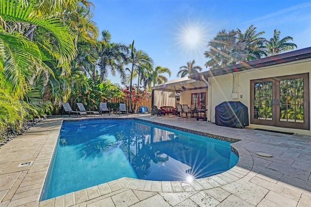 view of pool featuring a grill, a patio area, and french doors