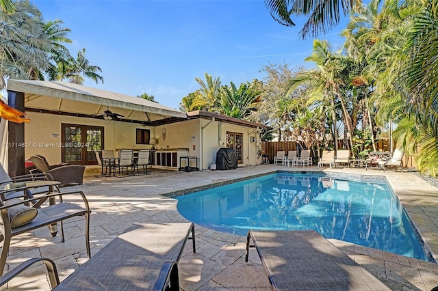 view of swimming pool with french doors, a patio, and ceiling fan