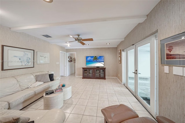 living room featuring ceiling fan, beam ceiling, light tile patterned floors, and french doors