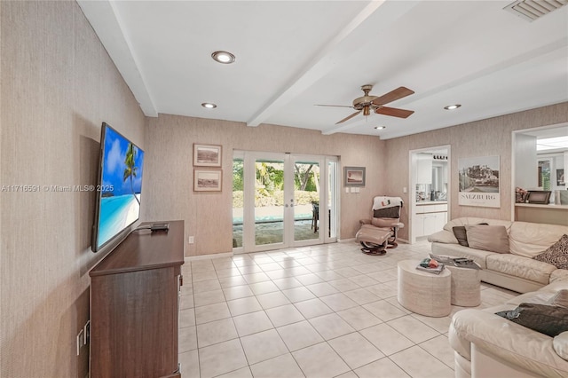 tiled living room featuring beam ceiling, ceiling fan, and french doors