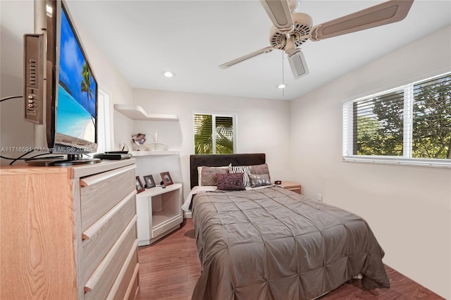 bedroom with ceiling fan and dark hardwood / wood-style floors