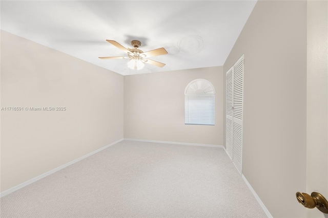 carpeted empty room with ceiling fan