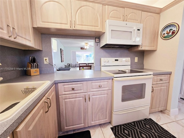 kitchen with light brown cabinetry, sink, white appliances, and tasteful backsplash